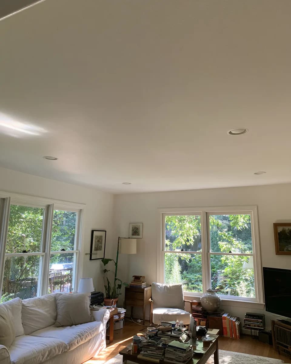 Living-room ceiling repaired and refinished by All Purpose Anytime Services, with recessed lights reset and the surface finished flat